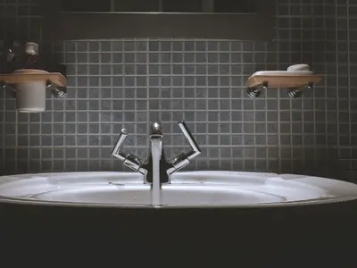 A modern chrome tap over a round basin