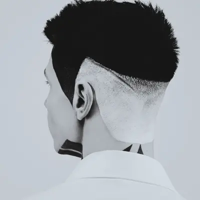 A high skin fade with a sharp line up, seen from behind