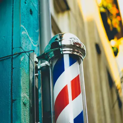 A red, white and blue barber's pole on a shop front