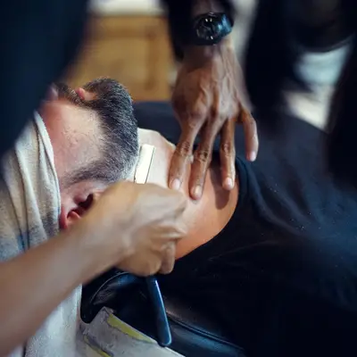 A barber giving a client a close shave